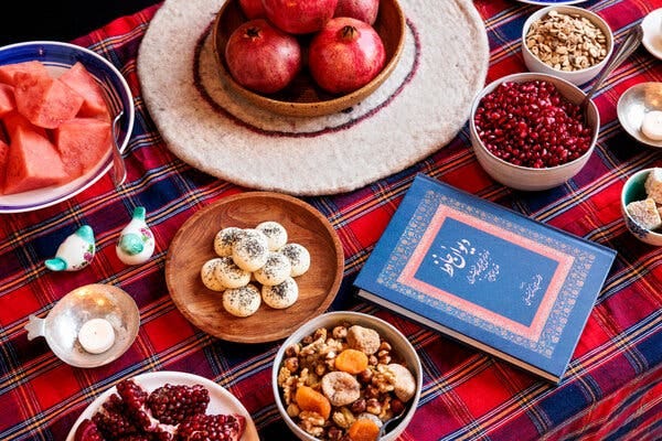 Foods for Yalda include, clockwise from top: pomegranates; hogweed to sprinkle on pomegranate seeds; baslogh (soft and chewy rosewater-infused walnut sweets); ajeel (mixed nuts, seeds and dried fruit); rice cookies and watermelon.