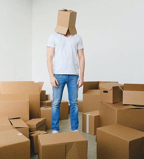 man wearing a box on his head lacks perspective.