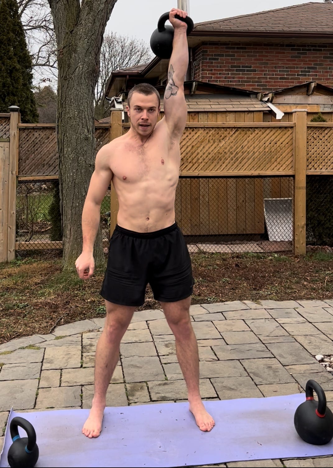 Single-arm overhead pressing a 24kg/53lb kettlebell (KB OHP) for 3 sets of 10 reps per side. January 2022.