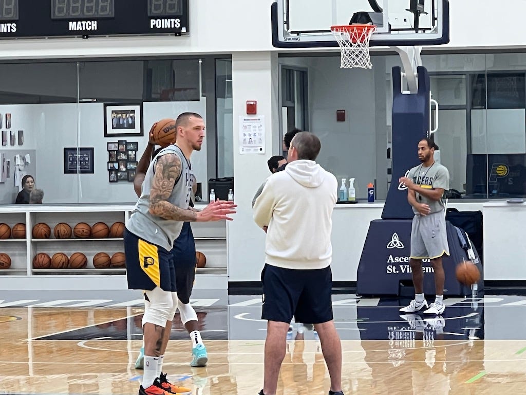 Daniel Theis talks with Pacers assistant coach Mike Weinar during training camp.