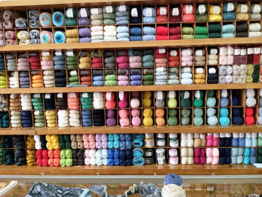 Shelves full of colorful skeins of yarn in Porto, Portugal.