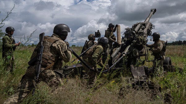 Ukrainian servicemen prepare to fire at Russian positions from a U.S.-supplied M777 howitzer in the Kharkiv region on July 14.