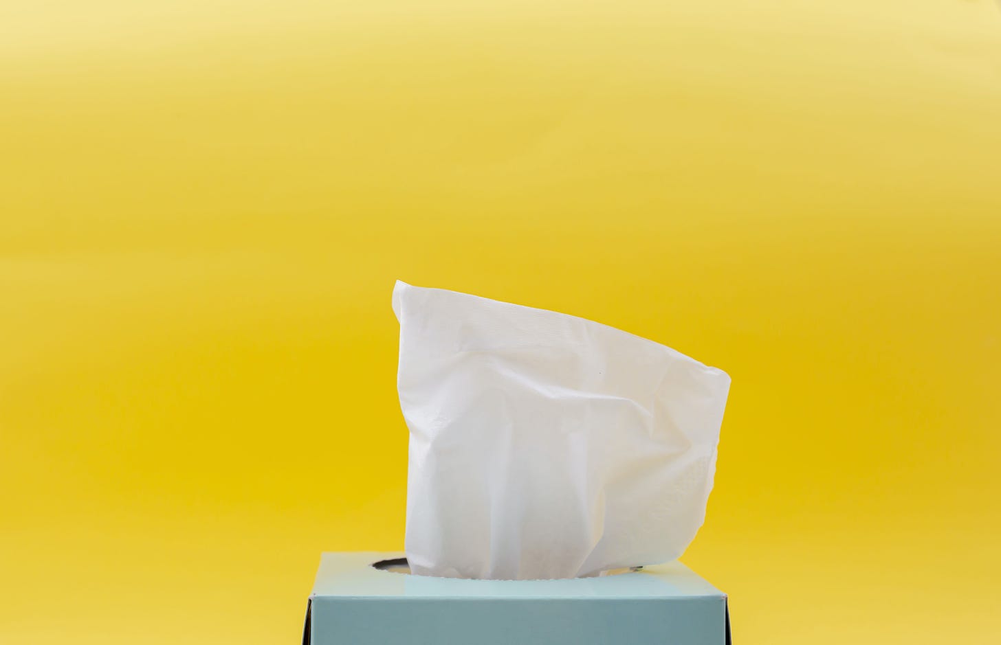Blue tissue box on a yellow background
