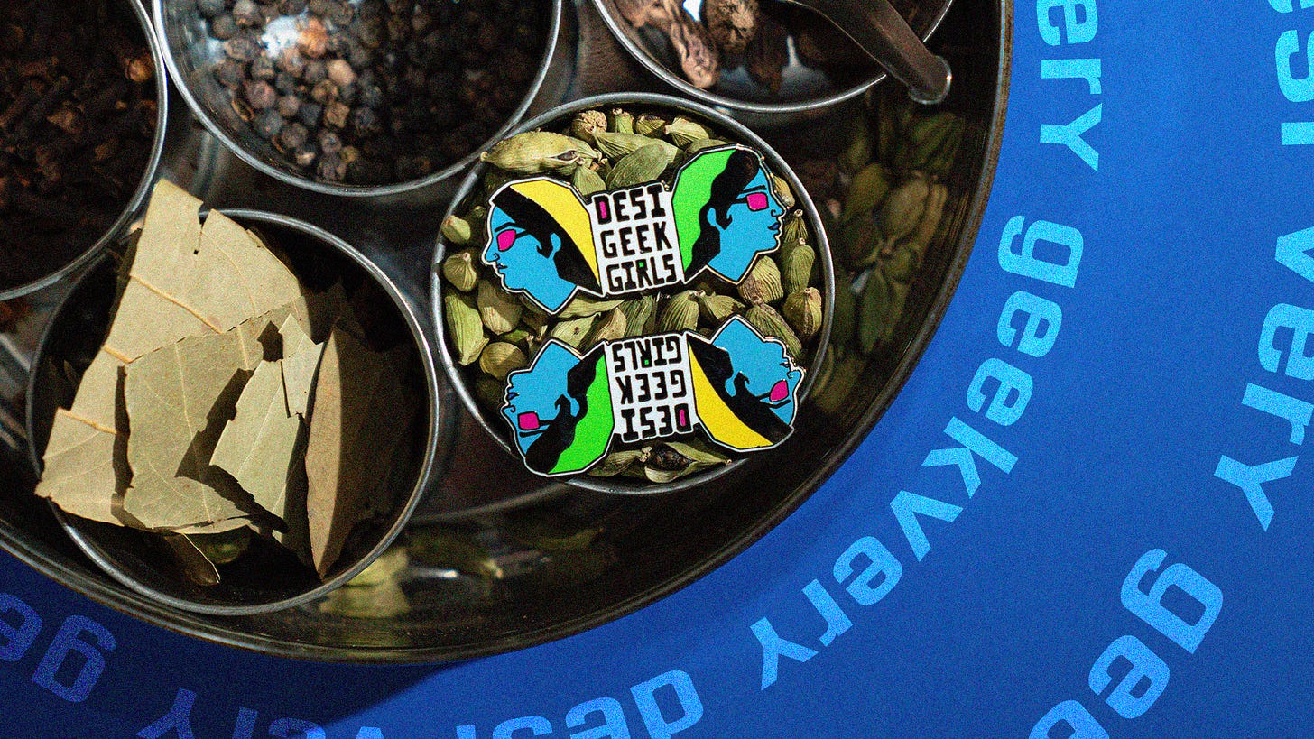 Desi Geek Girls logo sitting in a bowl of cardmom pods, surrounded by other spices
