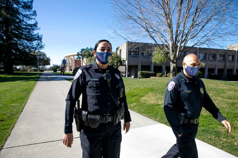 Campus police officers Tejinder Arurkar, left, and Lt. Omar Miakhail walk around the Cal State East Bay campus in Hayward on Feb. 17, 2021. CSUEB has one of the most diverse campus police departments in the state. Photo by Anne Wernikoff, CalMatters