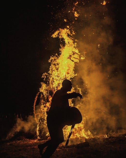 Person Silhouette Near the Fire