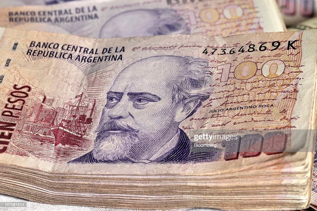 Stacks of 100 Argentine peso notes are displayed for a photograph in...  News Photo - Getty Images