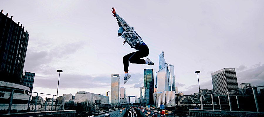 Person leaping through the air city in background