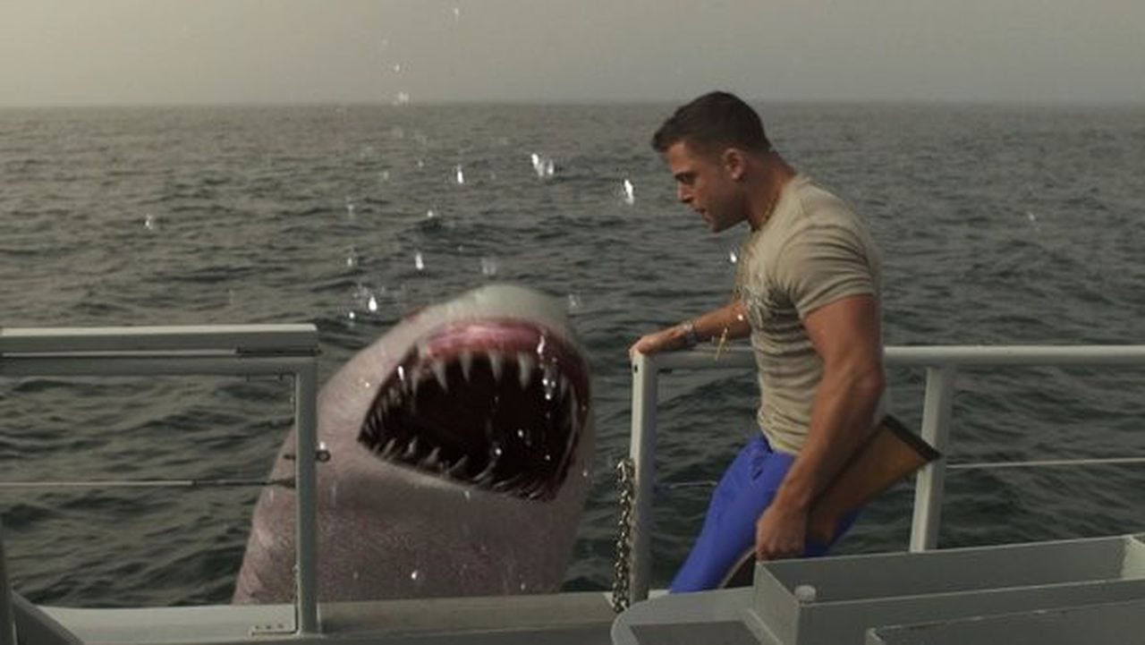 Movie still from Jersey Shore Shark Attack. A Jersey Shore guy lookalike stands on a boat next to a shark jumping out of the water.