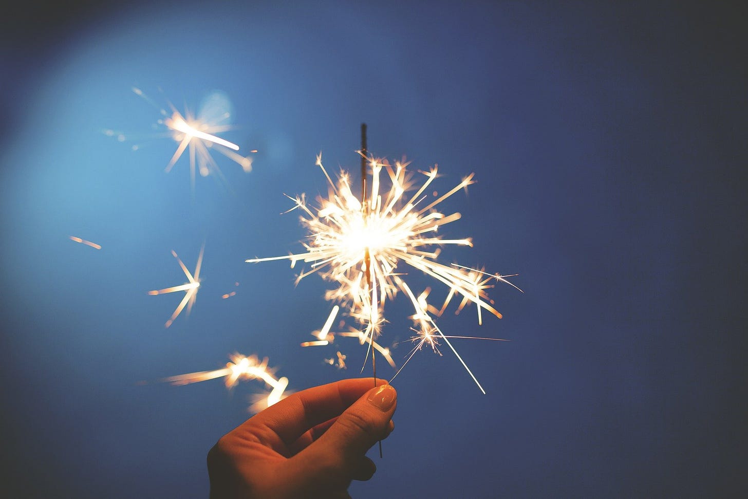 A sparkler : a hand held firework representing celebrations