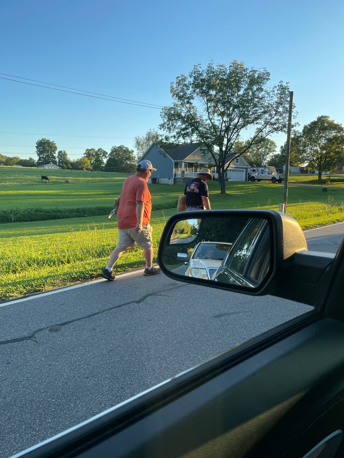 two guys walking down the road
