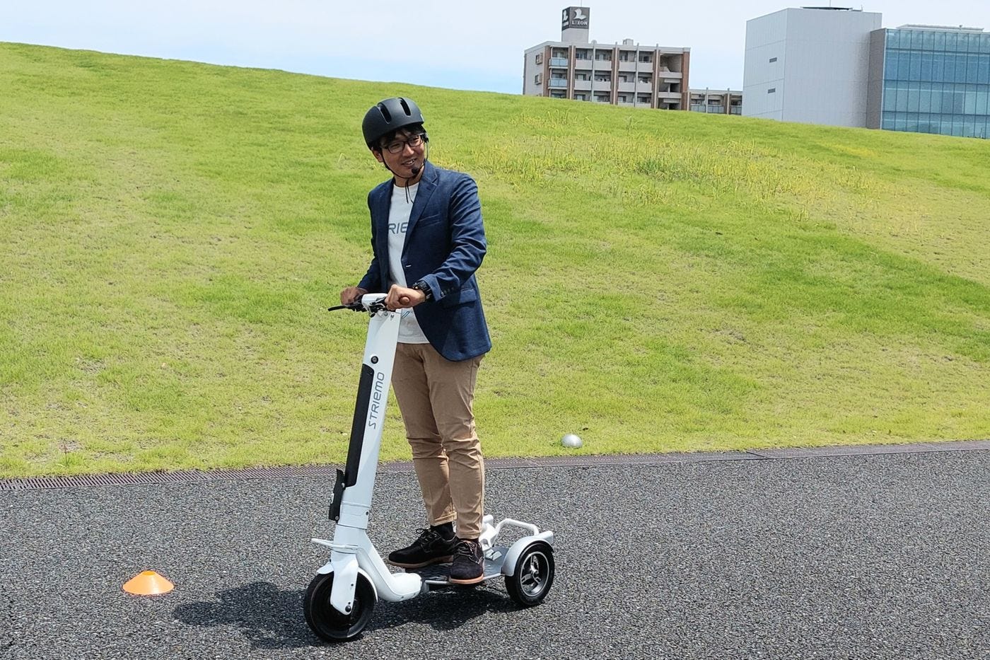 Yotaro Mori, chief executive officer of Striemo, rides the company's electric scooter at Honda's R&amp;D center.