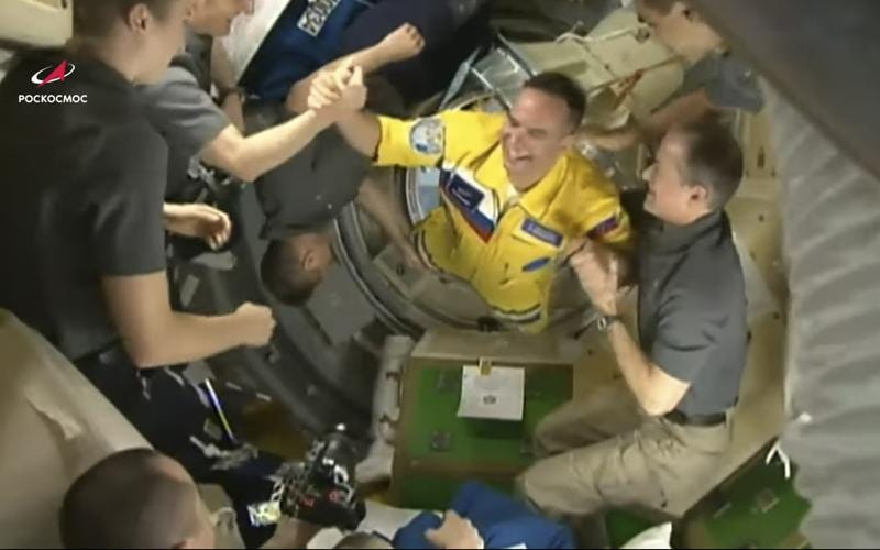 In this photo taken from video footage released by the Roscosmos Space Agency, newly arrived to the ISS, Russian cosmonaut Sergei Korsakov, centre, says hello to other participants of expedition to the International Space Station, ISS, after docking the Soyuz MS-21 space ship to the station, Friday, March 18, 2022. (Roscosmos Space Agency via AP)
