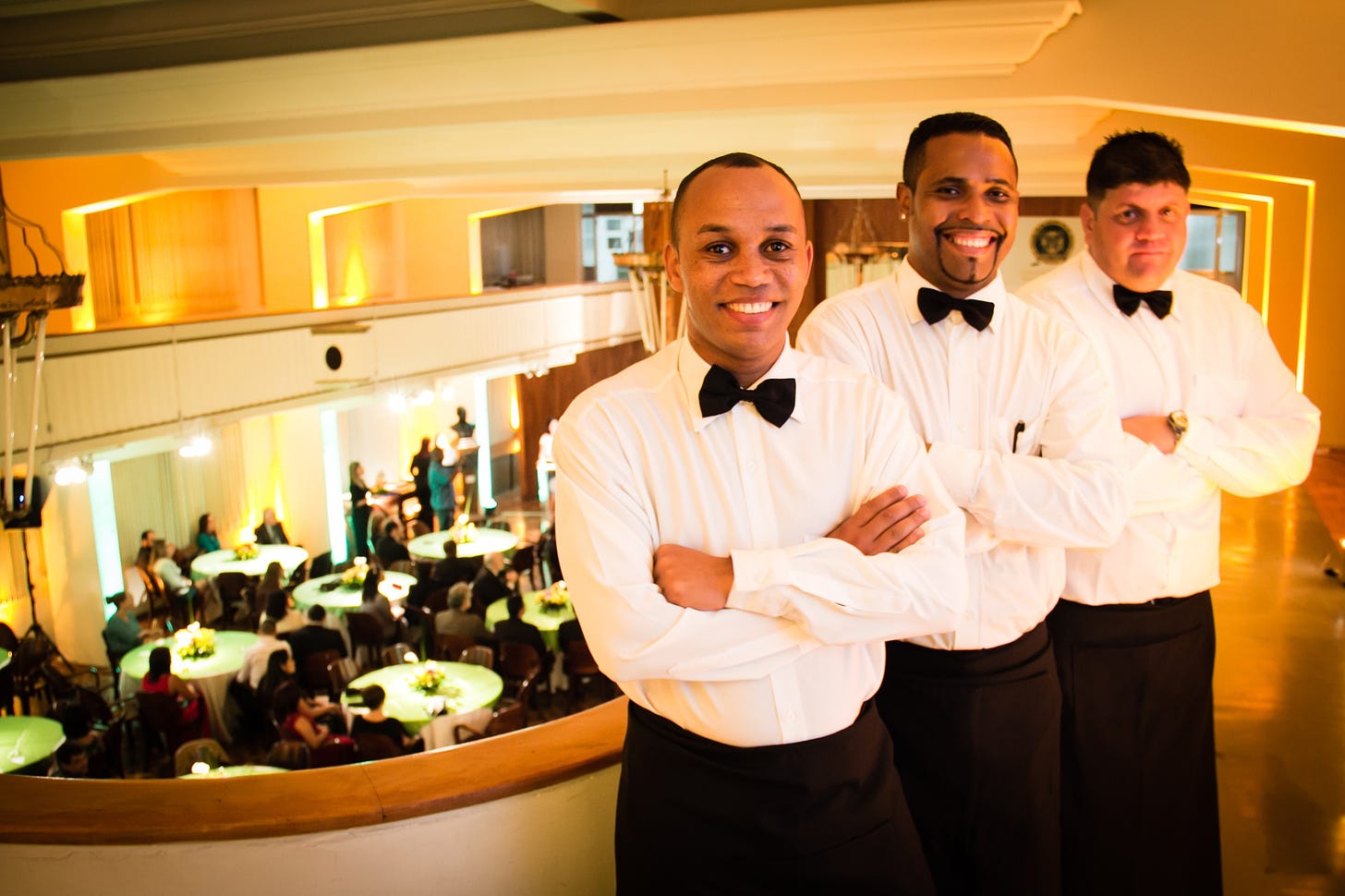 Three waiters posing