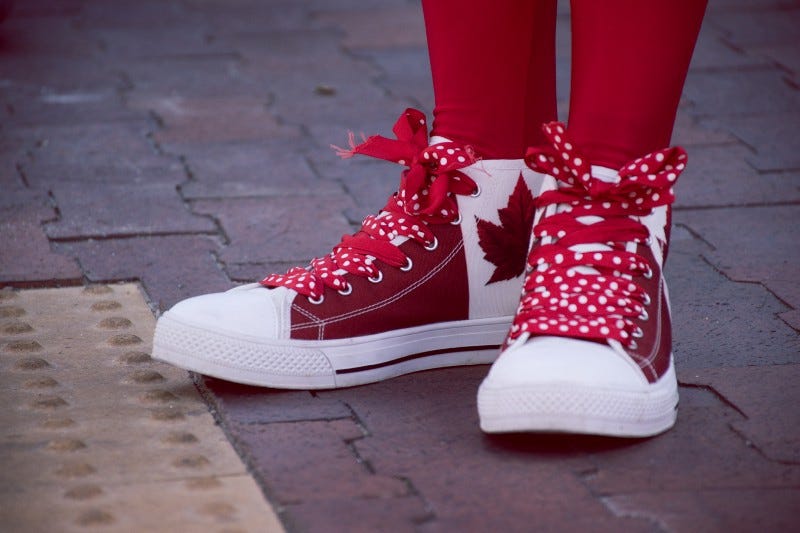 Red shoes with a Canadian flag on them.
