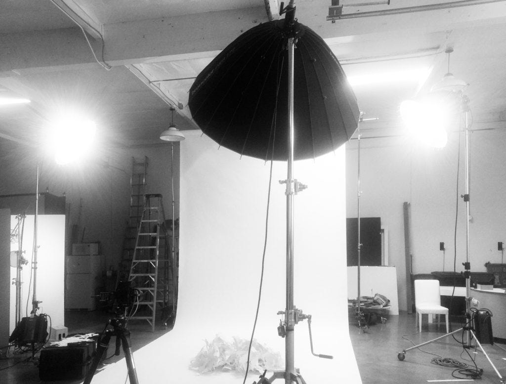 Behind the scenes of a portrait studio with a white paper seamless background and lights on stands. Set safety back then mean not tripping on extension cords. Behind the scenes of a portrait studio with a white paper seamless background and lights on stands. Set safety back then mean not tripping on extension cords.