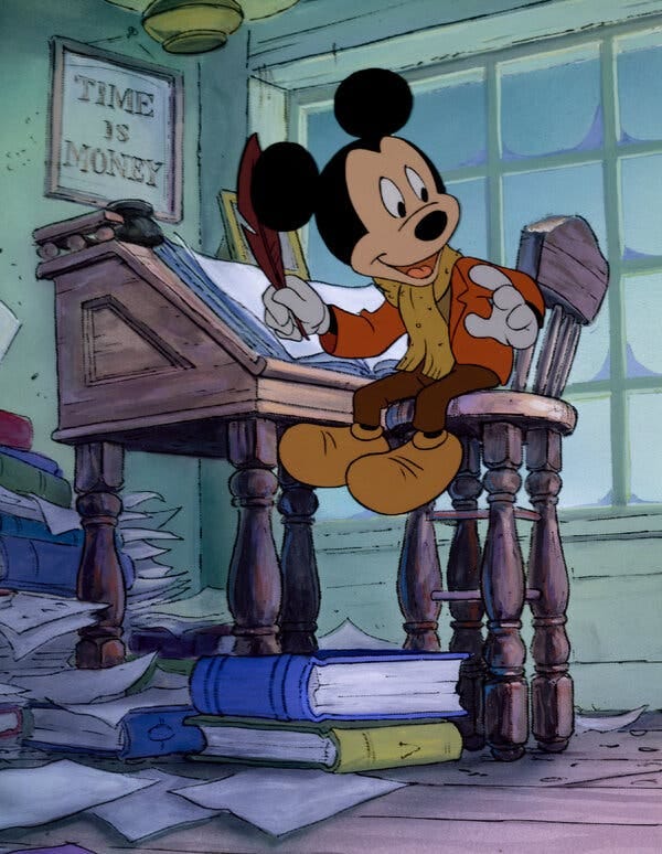 Mickey Mouse sitting at a desk in a scene from “Mickey’s Christmas Carol.”