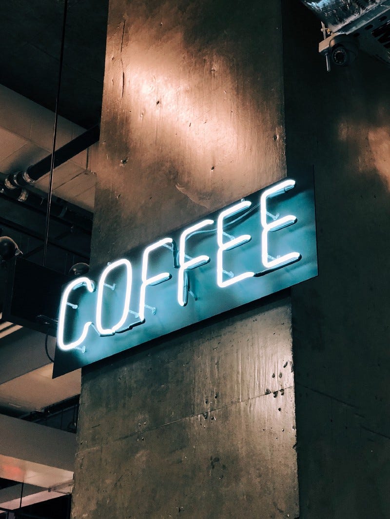 A neon sign with the word “coffee”.