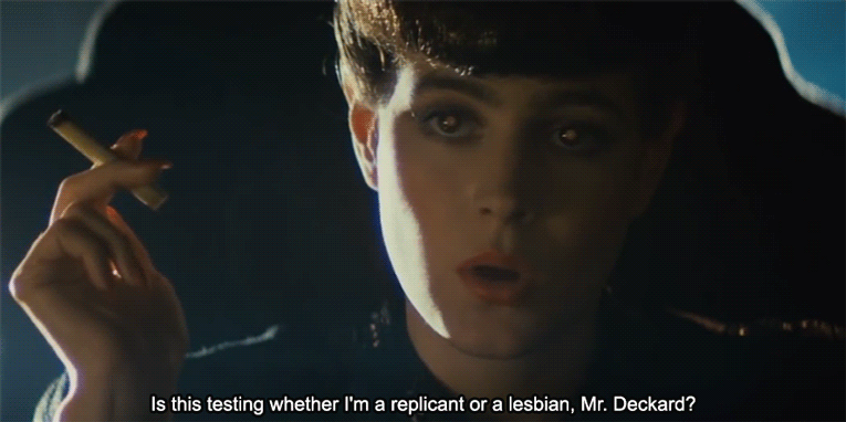A gif of Sean Young as Rachael from Blade Runner asking: "Is this testing whether I'm a replicant or a lesbian, Mr. Deckard?"