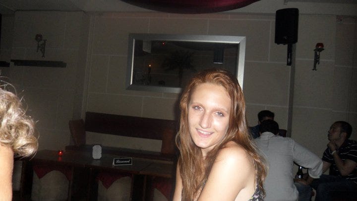 Larissa Marten, age 16, at a bar, smiling to camera.