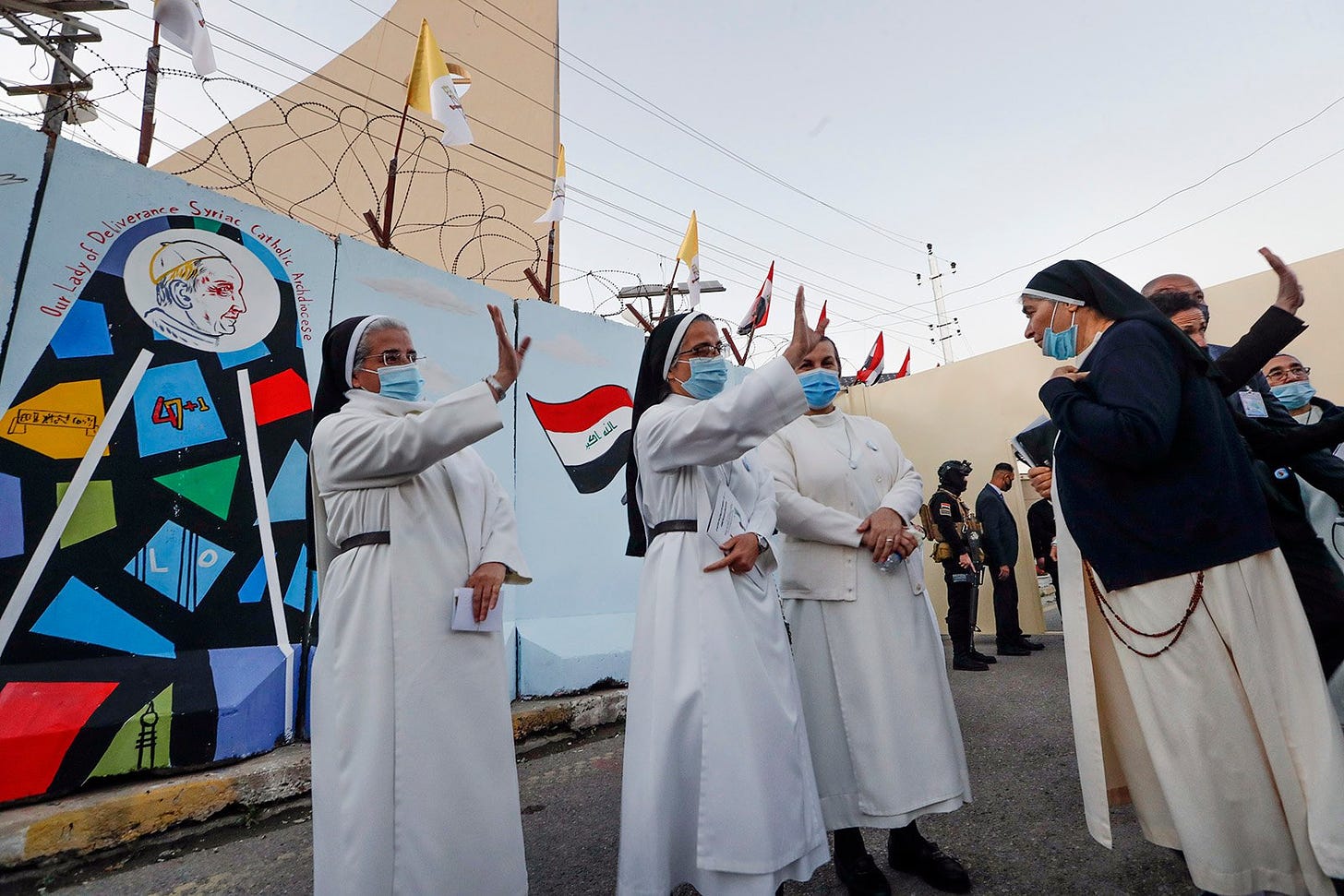 Nuns waves as Pope Francis leaves the Sayidat al-Nejat (Our Lady of Salvation) Cathedral, in Baghdad, Iraq, Friday, March 5, 2021. Pope Francis has arrived in Iraq to urge the country's dwindling number of Christians to stay put and help rebuild the country after years of war and persecution, brushing aside the coronavirus pandemic and security concerns. (AP Photo/Andrew Medichini)