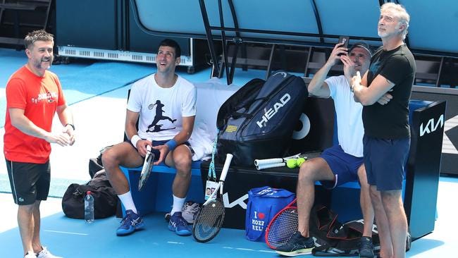 Serbia's Novak Djokovic watches as coach Goran Ivanisevic films news helicopters flying above as they take part in a training session in Melbourne on Tuesday. Picture: AFP