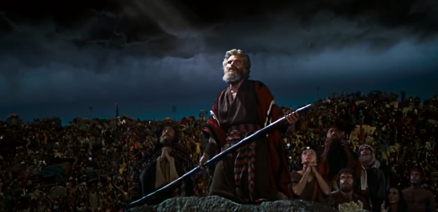 A bearded Mosaic Charlton Heston and the people gaze skyward in The Ten Commandments 