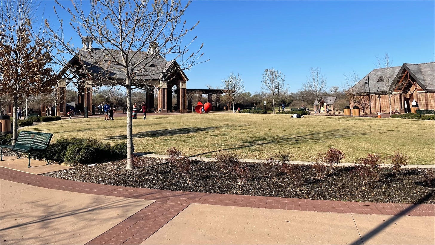 A circular patch of grass near the parking lot of Andrew Brown Park East