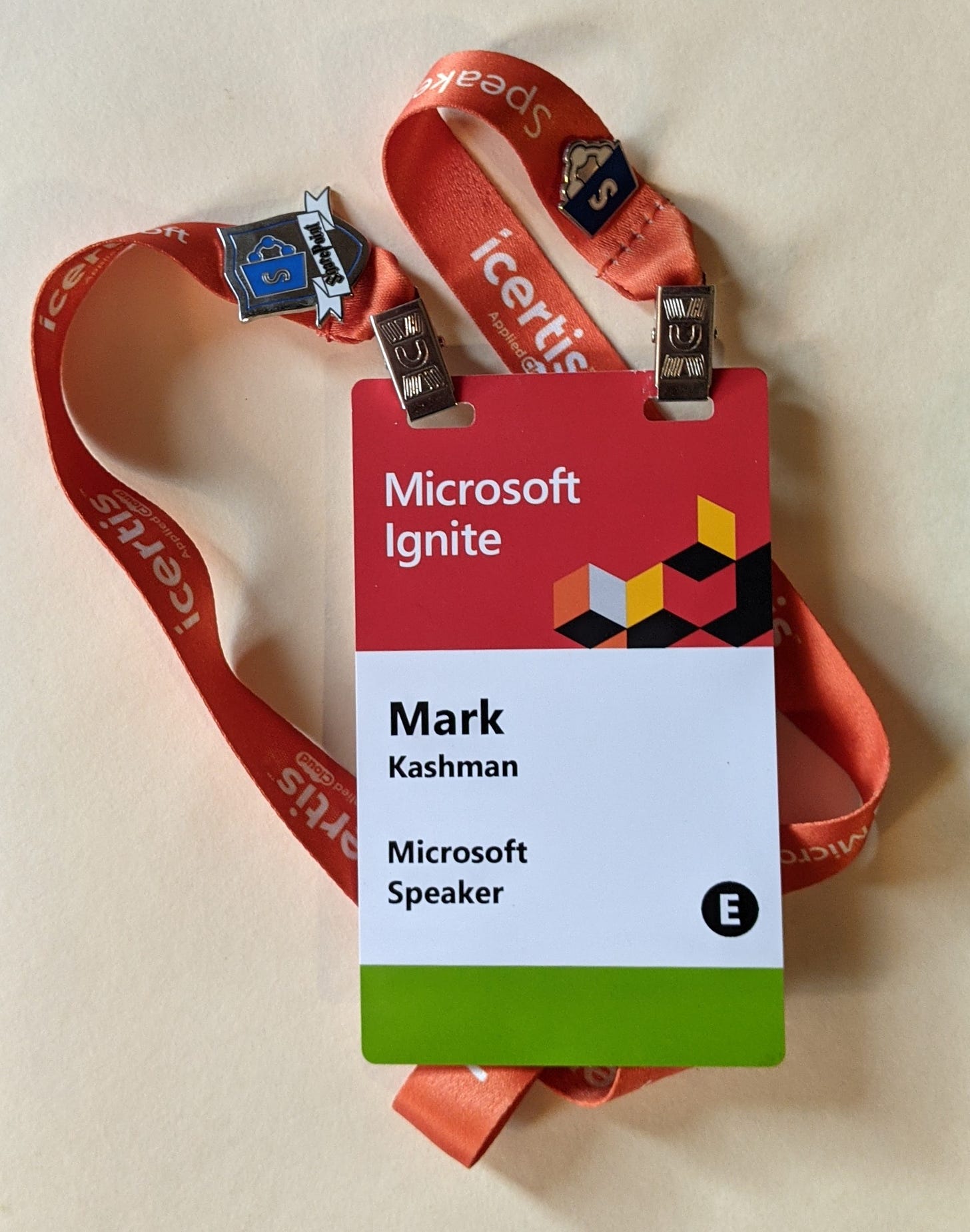 Microsoft Ignite 2019 event badge with SharePoint pins.