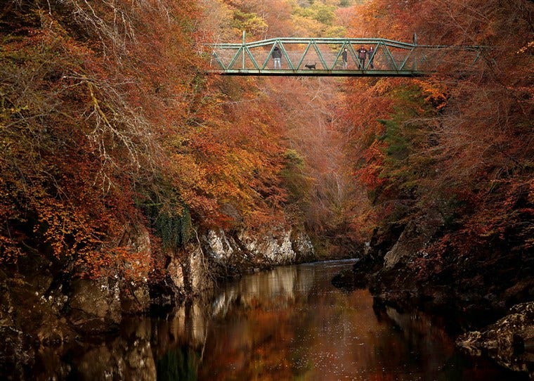Image: People walk on the bridge over the river Garry, Pitlochry, Scotland
