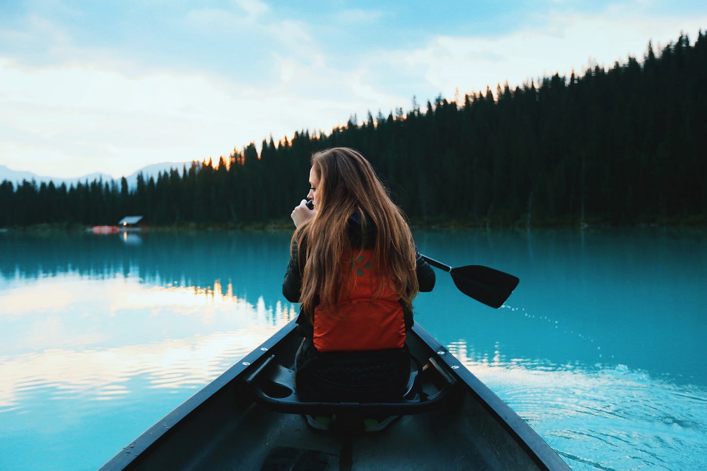 image of a girl in a canoe on a still lake for article by Larry G. Maguire