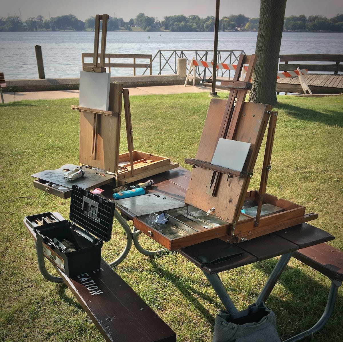 Easels on a picnic table at the park.