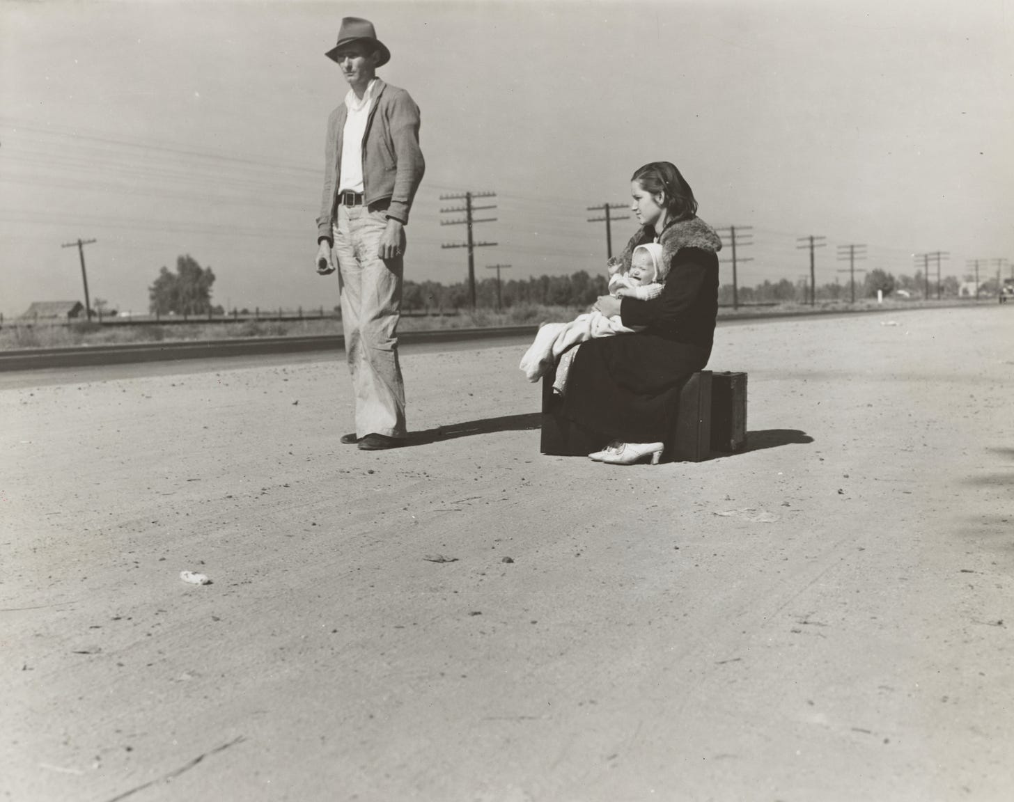 Young family, penniless, hitchhiking on U.S. Highway 99, California. The father, twenty-four, and the mother, seventeen, came from Winston-Salem, North Carolina, early in 1935 Photographer Dorothea Lange