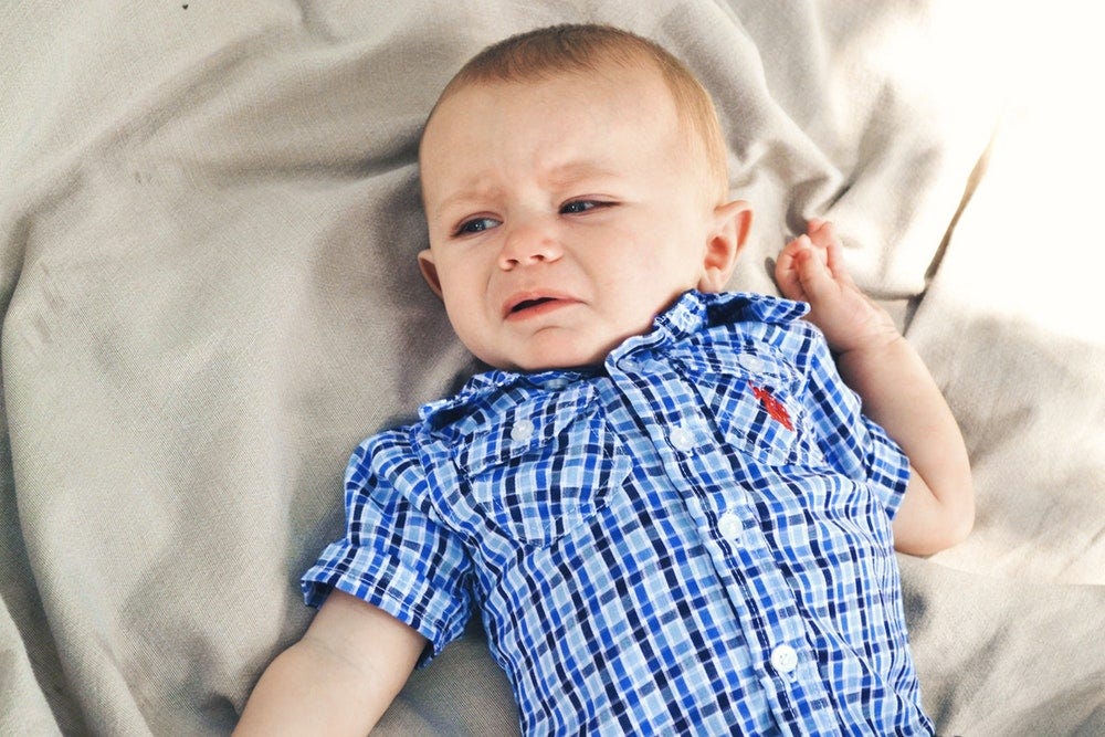 boy wearing blue, black, and gray plaid sport shirt