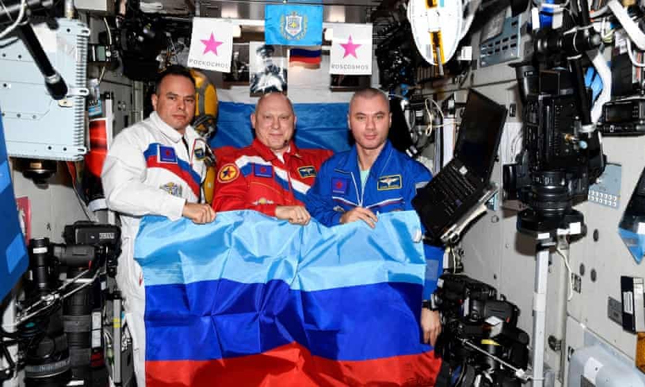 Russian cosmonauts Oleg Artemyev, Denis Matveev and Sergey Korsakov pose with a flag of the self-proclaimed Luhansk People's Republic at the International Space Station.