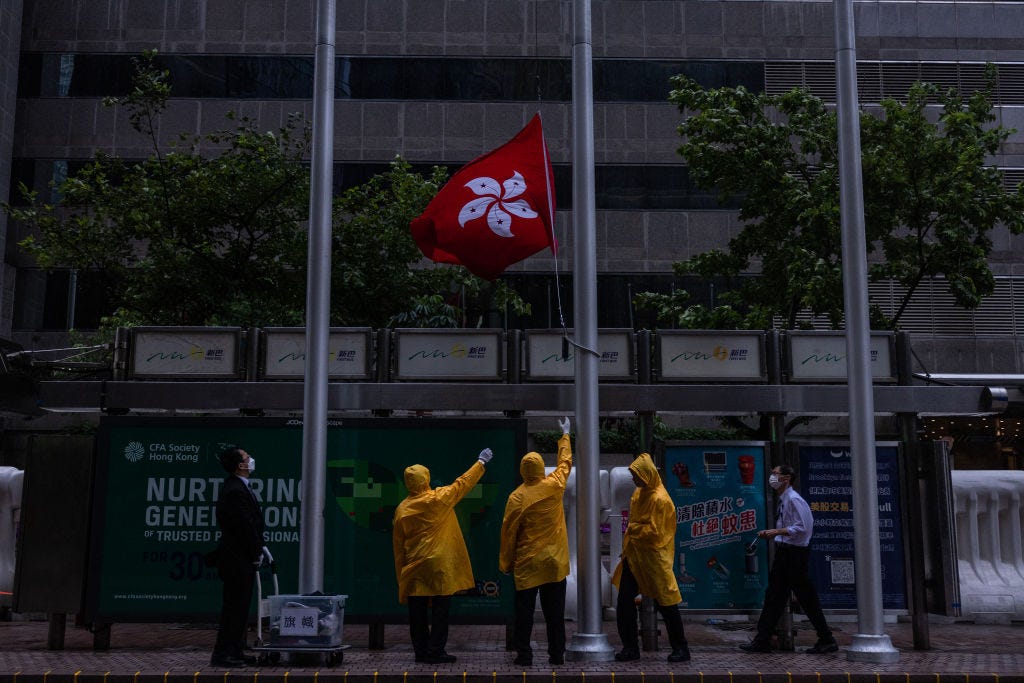 A Hong Kong flag is lowered during a typhoon on July 1 in Hong Kong, China. (Photo by Louise Delmotte/Getty Images).