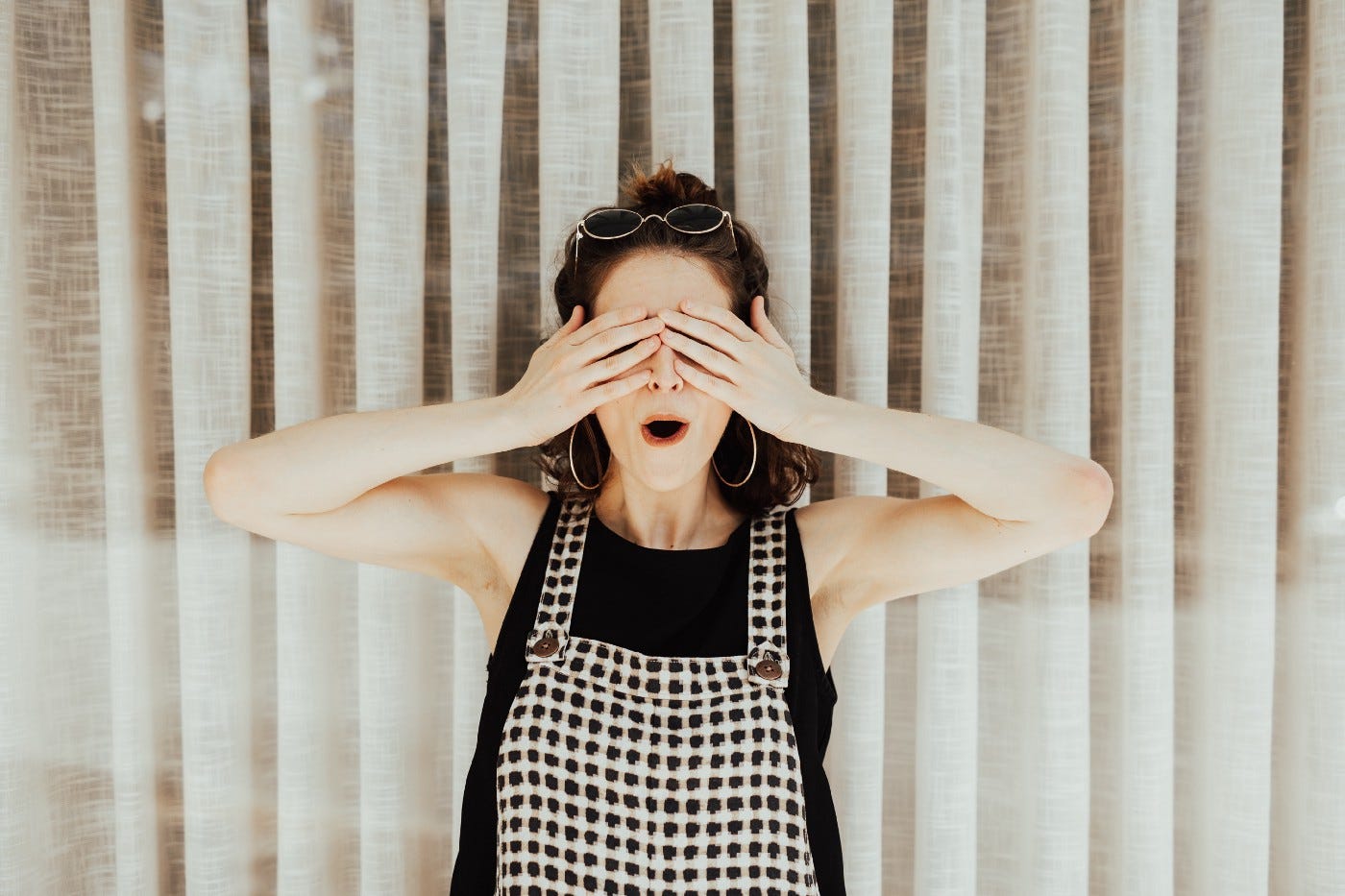 Woman covering eyes with hand because of the one content mistake she made