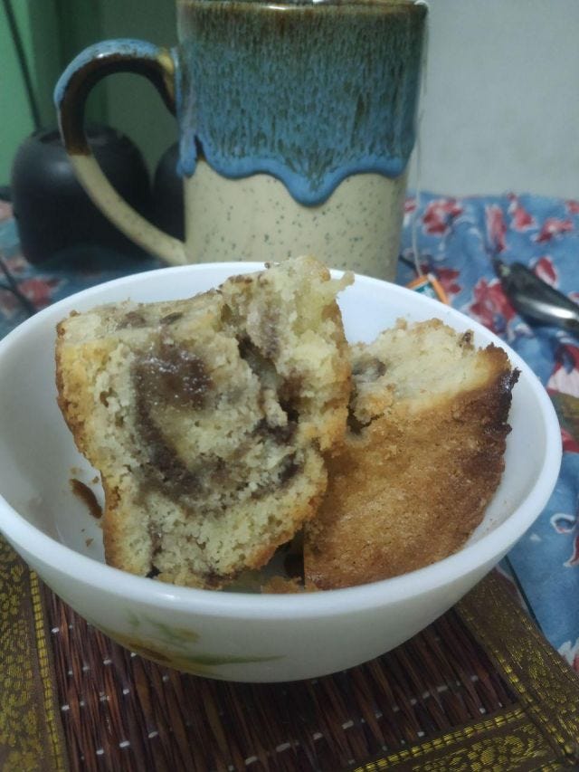 A bowl of cake with nutella swirls within a pound cake.