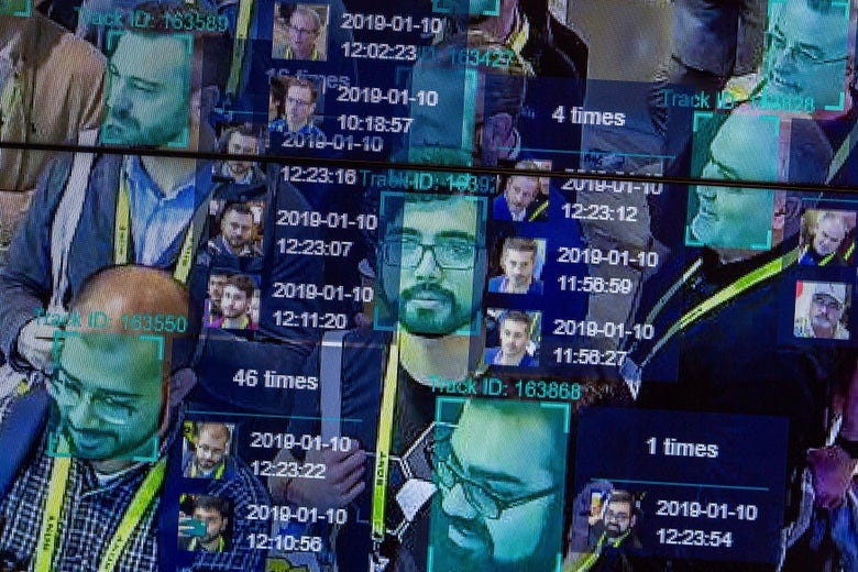 Faces in a crowd are overlaid with computer data from facial recognition technology. 