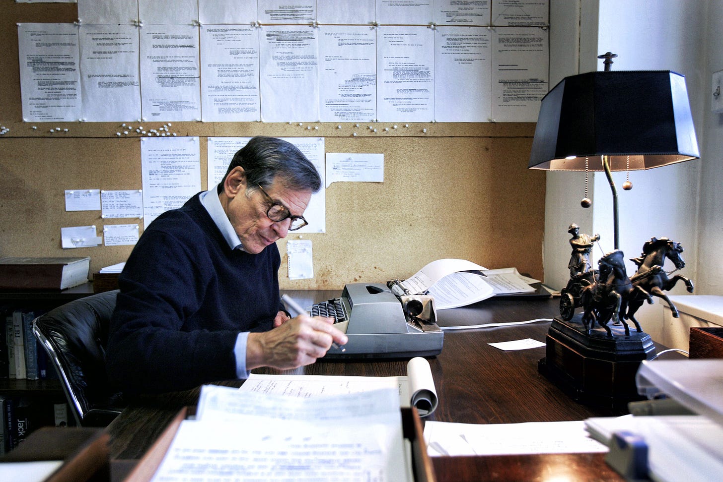 A photograph of the author Robert A. Caro at work in his office.