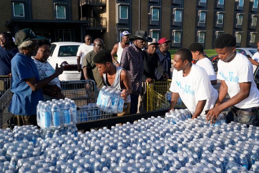 People are given cases of bottled water