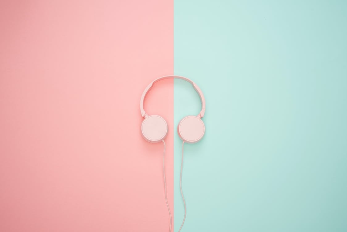 Free Pink Corded Headphones on pink and teal Wall Stock Photo