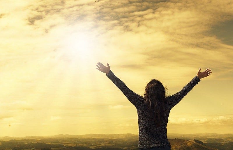 Woman cheering to the sun Woman cheering to the sun