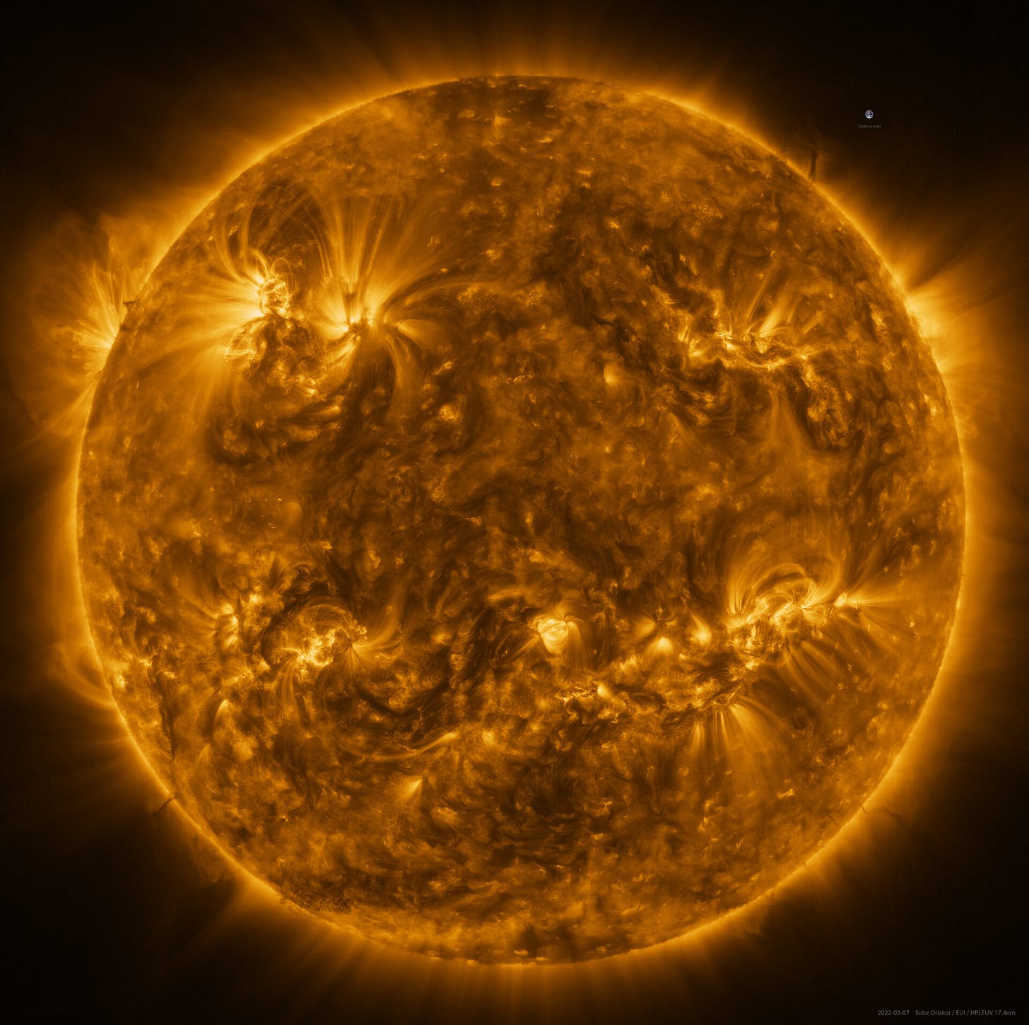 A very high res photo of the sun that kind of looks like a melted and stitched back together smiley face.