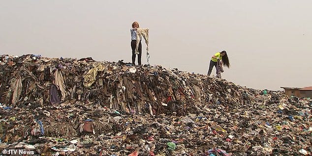 What a waste: ITV’s Penny Marshall (left) and Liz Ricketts of The OR Foundation wade through a clothing mountain in Accra