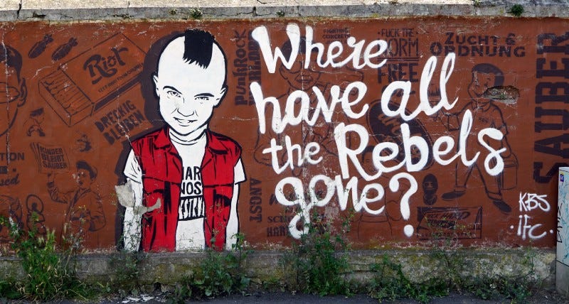 A painted wall with a punk. Where have all the rebels gone?