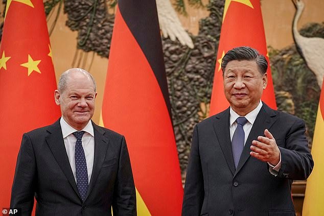 Xi Jinping (right) is pictured on Friday meeting with German Chancellor Olaf Scholz in Beijing