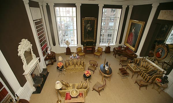 <strong>LIGHT AND COLOR</strong> The walls of Carolyne Roehm's double-height drawing room are covered in brown velveteen. 