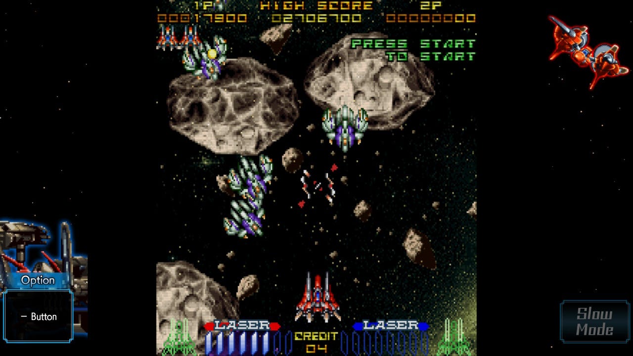 A screenshot from the game's first stage, showing your ship at the bottom, as asteroids and enemies approach from above. The HUD is rather busy, with scores, extra lives, and weapon levels all displayed, but it plays into the intentionally cramped presentation and gameplay