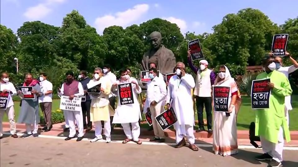 Opposition MPs hold placards as they protest demanding to clear the GST dues to states, in front of Mahatma Gandhi Statue at Parliament during the Monsoon Session, in New Delhi on September 17, 2020.